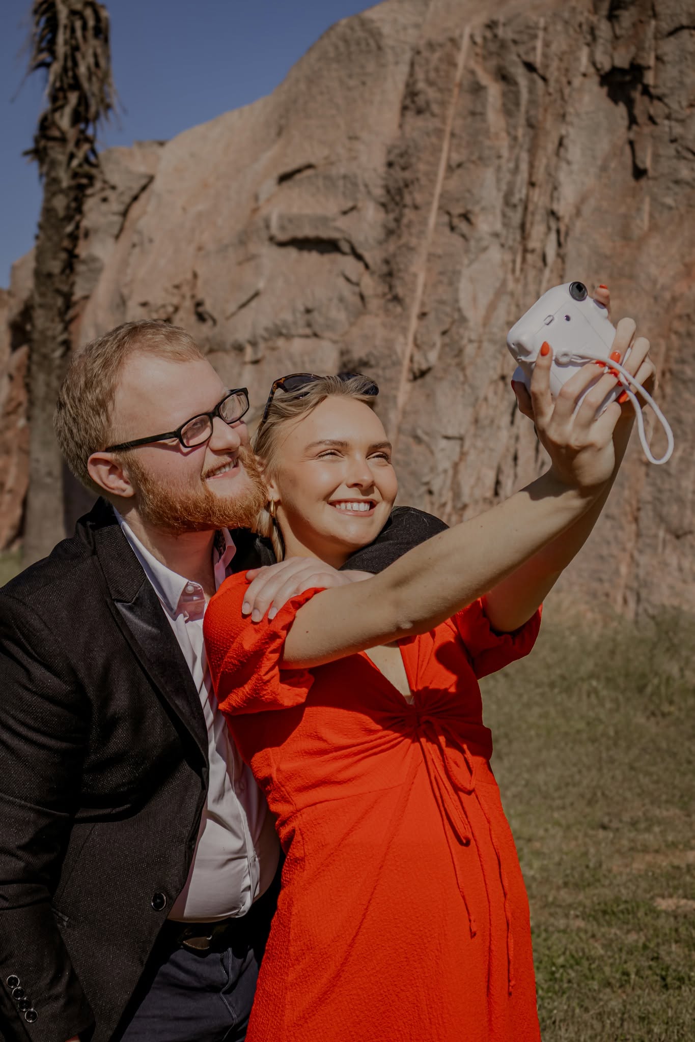 A couple creating a joyful instant-camera memory